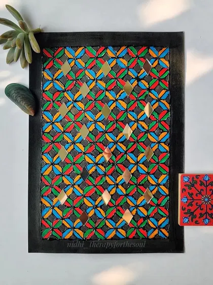 Another piece from the 'Rann ke Rang' series, this one uses a vibrant, multi-color palette of red, green, blue, and yellow. The diamond-shaped mirrors are integrated into the repeating pattern.