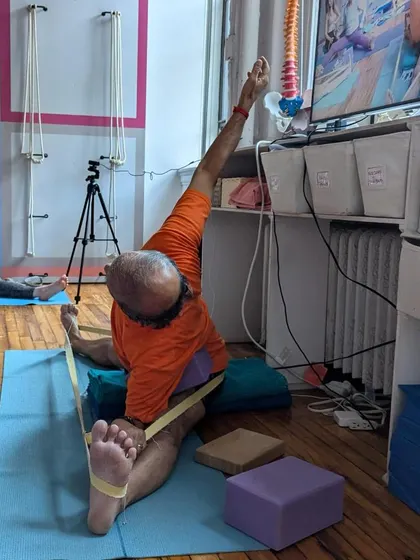Teaching Parivrtta Janu Sirsasana with props at Samamkaya Yoga in New York. The use of technology allows us to share these teachings in a hybrid format.