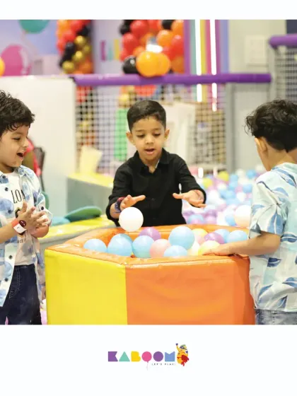 Friends working together at the ball station, a fun and engaging activity within our play area.