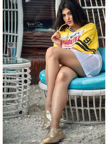 This image shows a playful and confident attitude. The clean makeup and simple hairstyle ensure the focus is on the model's expression and the casual, trendy fashion.