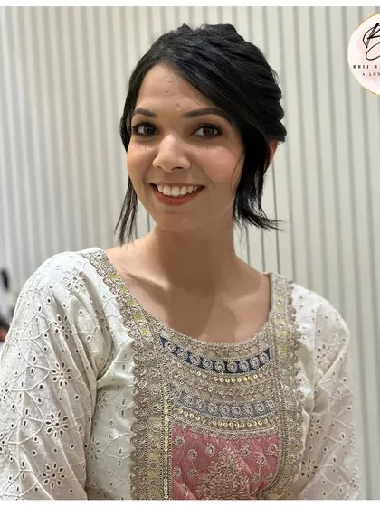 A happy client with her elegant updo. The style is clean and sophisticated, with soft tendrils to frame her face beautifully.