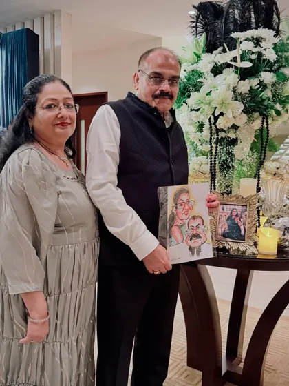 A beautiful moment with a couple and their newly created caricature portrait, placed elegantly in their home. It serves as a lasting and fun reminder of a special day.