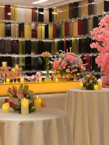 The ambiance was enhanced with dozens of candles placed strategically around the venue, casting a warm glow on the pink flowers and elegant table settings.