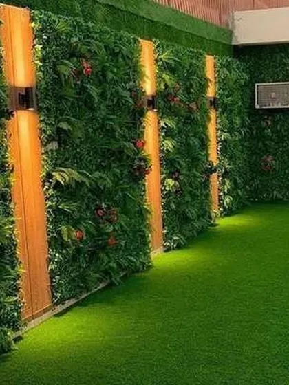 Another angle of the indoor vertical garden with integrated lighting. The warm lights bring out the different shades of green and create a cozy, inviting ambiance in the evening.