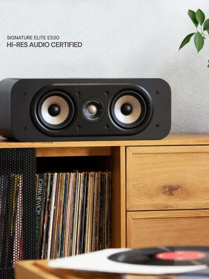 The Polk Signature Elite ES30 center channel speaker is Hi-Res Audio Certified, ensuring it can reproduce sound with incredible detail and clarity. It is shown here in a classic vinyl listening setup, proving its versatility for both movies and music.