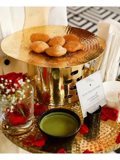 A tray of Bedmi Puri with Aloo, presented in a beautiful golden serving dish with green chutney, offering a taste of authentic North Indian street food.