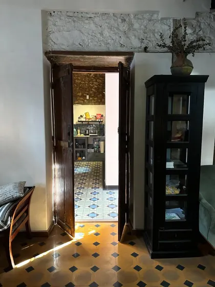 The afternoon sun casting long shadows across the floor of my studio. The way light moves through a space is a critical part of my design process. Here, it highlights the texture of the old floors and the history in the walls.