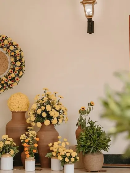 A corner arrangement showing the variety of pots and floral arrangements used to create a cohesive Haldi decor theme.