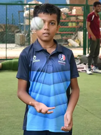 A young player having fun while practicing his ball skills. We believe in creating a positive and enjoyable learning environment.