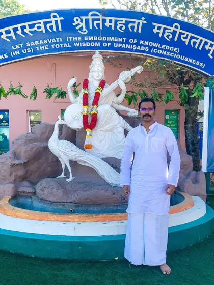 Standing before the statue of Goddess Saraswati at the S-VYASA campus. Her blessings represent the total wisdom of knowledge and consciousness that we seek through yoga.
