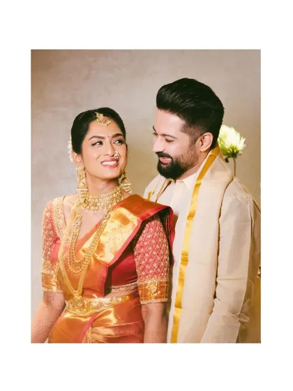 A happy and classic portrait of the couple in their traditional South Indian wedding attire. Their smiles and connection are the heart of this image.