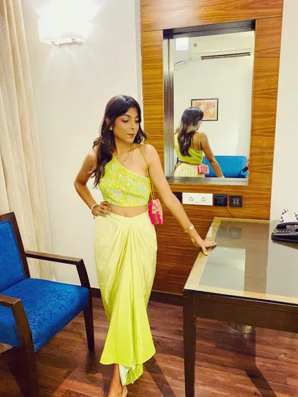 A full-length shot of the neon fusion outfit. The modern silhouette and bright color make it a great choice for someone who wants to try something different from a typical lehenga or suit.
