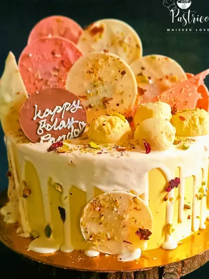 For the ultimate rasmalai lover, this cake is overloaded with the good stuff. It features a white chocolate drip and is decorated with beautiful pistachio and rose chocolate discs.