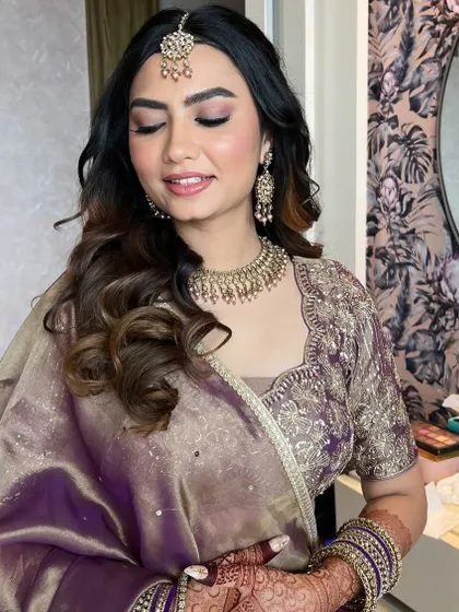 A close-up of the engagement makeup, showing the soft pink and purple eyeshadow. The skin is kept luminous and fresh, allowing the bride-to-be's joy to shine through.