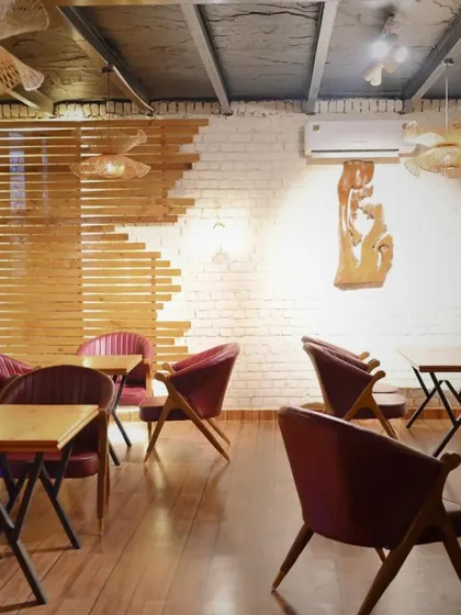 Another angle of our indoor seating, showing the blend of modern design with rustic brick and wood elements.