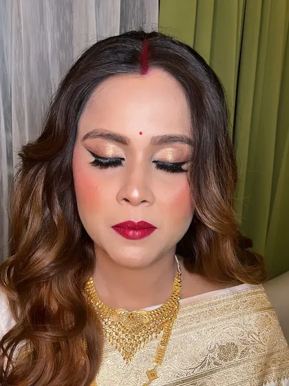 A close-up of the classic makeup look, featuring winged eyeliner and a bold red lip.