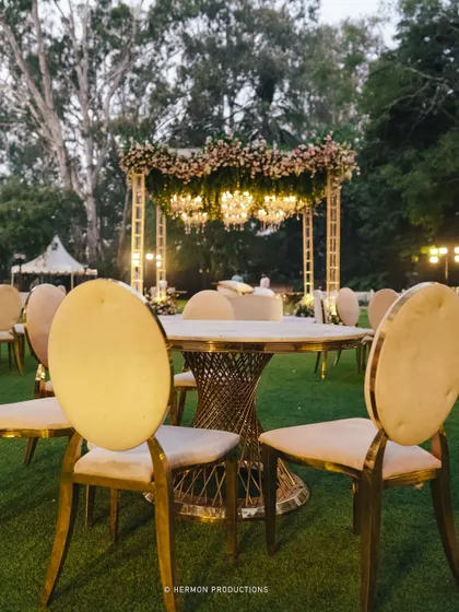 For this Bridgerton-inspired event, we created a magical setting with elegant seating and a floral-draped canopy structure housing sparkling chandeliers.