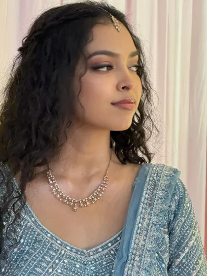 A profile shot of Sushmita, showing the soft contour and highlight. Her makeup is perfectly blended for a seamless, natural finish.