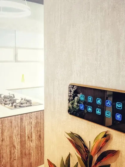 This is a real-world installation of a sleek, multi-button smart panel in a modern kitchen. It provides one-touch access to different lighting scenes and functions, blending perfectly with the home's design.