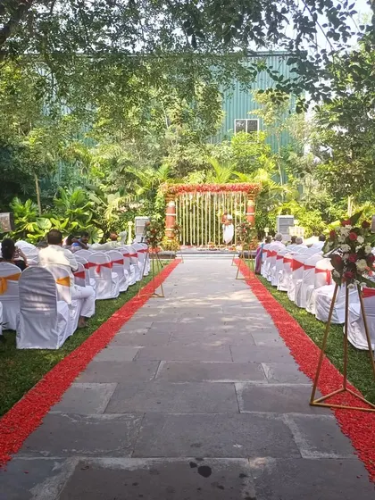 The aisle leading to a traditional South Indian mandap, lined with chairs for guests.