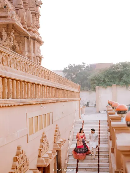 A high-angle shot of the couple walking down the temple stairs, creating a beautiful leading line and sense of movement.