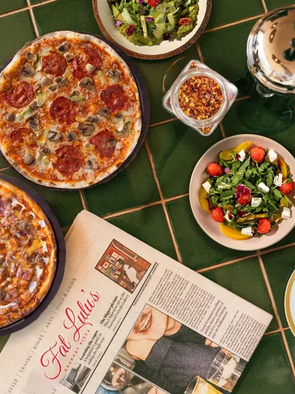 The full Fat Lulu's experience is about more than just one dish. It's a spread of gourmet pizzas, fresh salads, and a vibrant atmosphere that brings a cool, urban cafe vibe straight to your event.