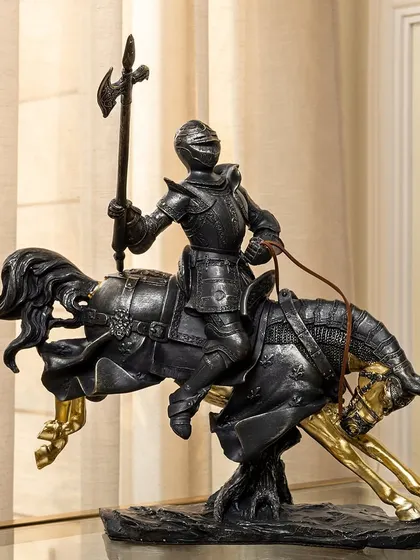 Embrace the spirit of bravery with this striking showpiece of a knight in full armor on a galloping horse. The intricate detailing and dynamic posture bring a strong, regal energy to any room.