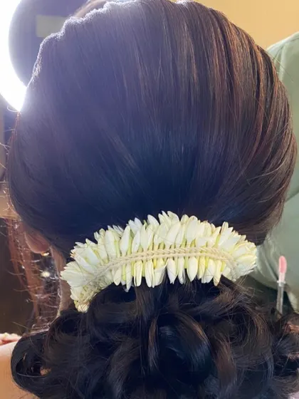 A detailed shot of the jasmine gajra on a classic bun, showing the fresh, fragrant flowers.