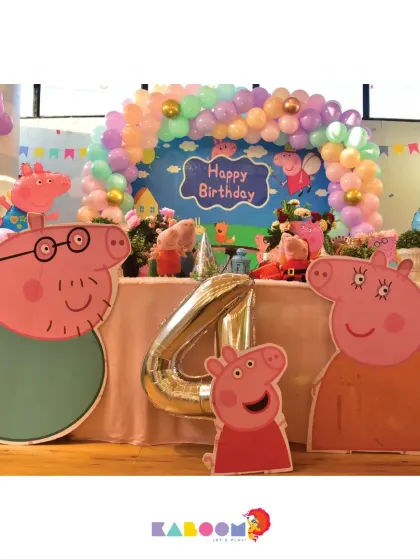 This Peppa Pig party setup features Daddy Pig and Mummy Pig, ready to celebrate with the birthday child. The colorful balloons and backdrop make for a fun and festive scene.