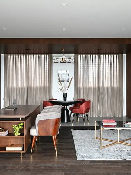 A wider view of the Chairman's office, showing how the main workspace flows into a comfortable lounge area. This multi-functional layout allows for both focused work and relaxed, informal discussions within a single, cohesive suite.