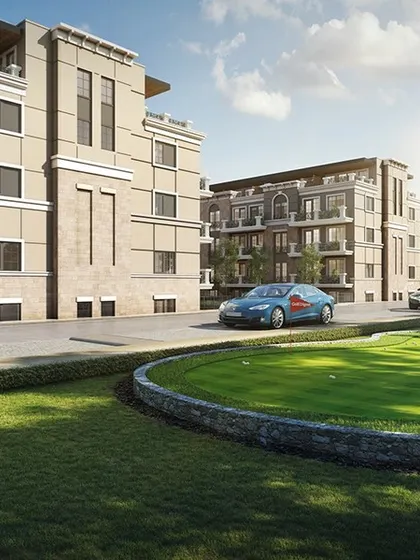 A view of the townhouse complex showcasing the community amenities, including a putting green and landscaped seating areas.