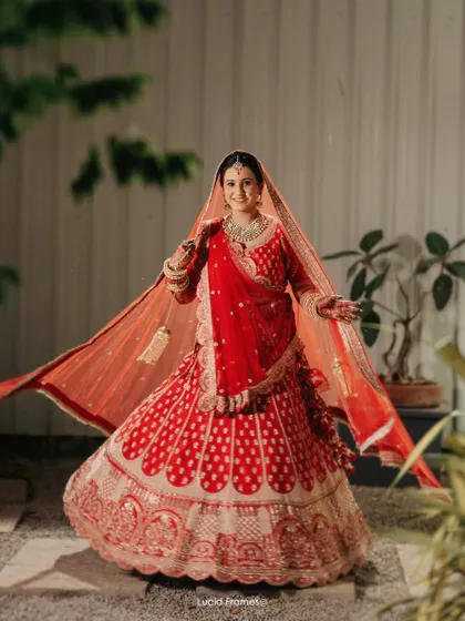 A joyful twirl from the bride in her stunning red lehenga, her happiness is infectious.