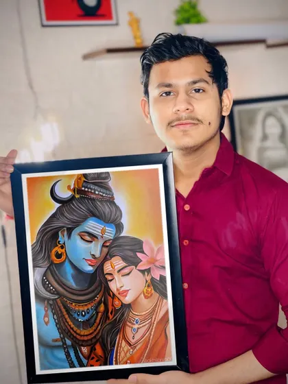Here I am, holding my framed artwork of Lord Shiva and Maa Parvati. It's always a proud moment to see a finished piece ready to go to its new home.