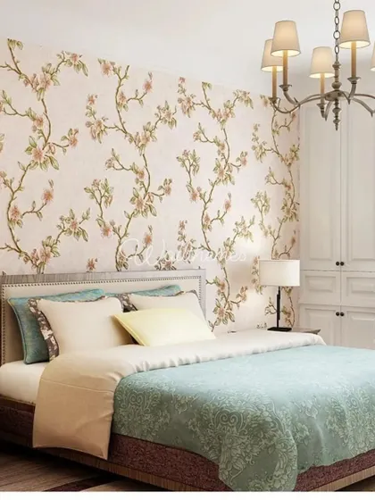 A bedroom featuring a subtle floral vine wallpaper in soft pinks and greens, adding a touch of nature to the space.