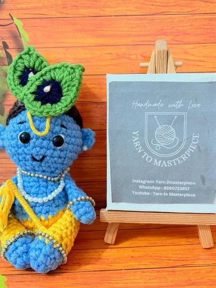 This is my handcrafted Shri Krishna amigurumi doll, a perfect spiritual keepsake. I've carefully crocheted his peacock feather, jewelry, and serene expression using vibrant, child-safe cotton yarn.