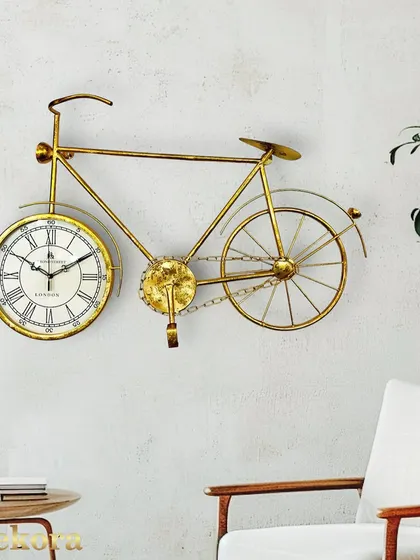 A favorite for its unique charm, this golden bicycle wall clock blends vintage inspiration with modern craftsmanship. The detailed metal frame and classic clock face make it a whimsical and stylish addition to a living room or creative space.