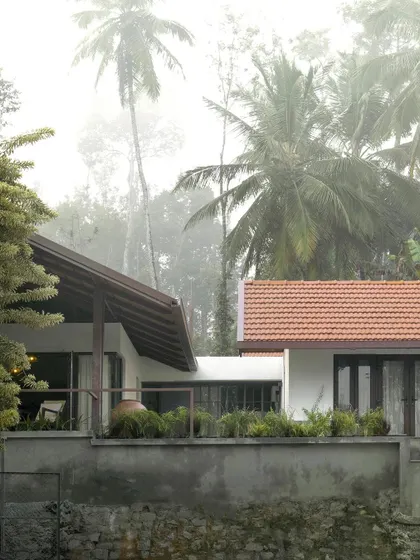 A view of the farmhouse from the coffee drying yard below. The structure is carefully sited on the slope to minimize its impact on the land while maximizing views and privacy.