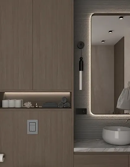 Another view of the wood-finish bathroom, highlighting the vertical storage unit and the soft, ambient light from the mirror and sconces.