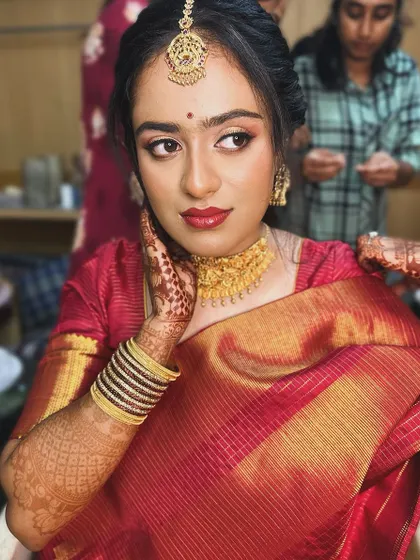 A behind-the-scenes shot of the bride getting ready, her makeup looking soft and beautiful.