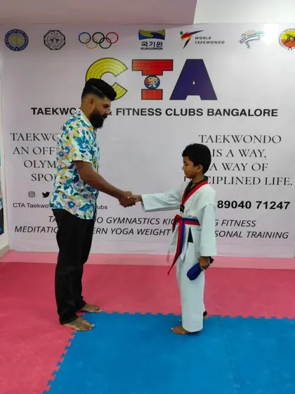 A handshake for a new red belt.