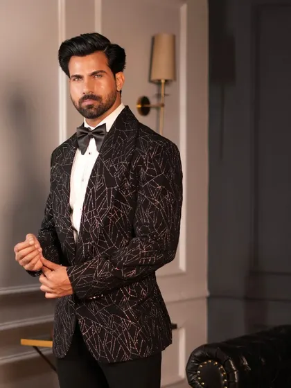 Adjusting the cuffs on the Starry Black Tuxedo, a gesture that speaks to the confidence our tailored garments inspire.