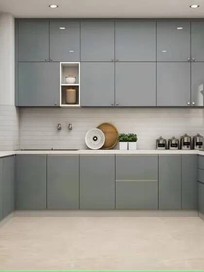 A sleek and modern U-shaped kitchen in a cool grey. The handleless cabinets and integrated appliances give it a very minimalist feel, while the white subway tile backsplash keeps it bright.