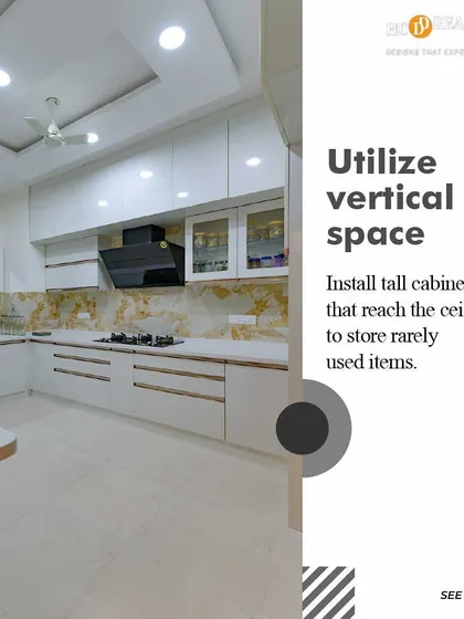We utilize every inch of space by designing tall, vertical cabinets that reach the ceiling. This is an excellent way to store rarely used items in the kitchen, keeping your countertops clear and your essentials within easy reach.