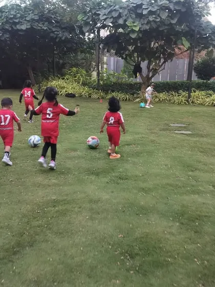 A dynamic shot of the kids running with their footballs. Our classes are full of movement, ensuring children stay active and engaged while learning the basics of the game.