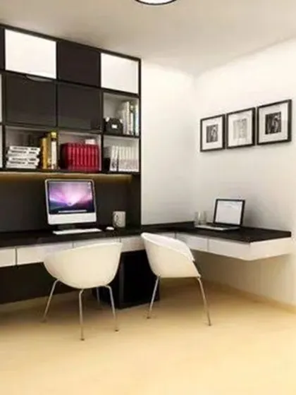 A contemporary home office with a black and white theme, featuring a floating desk and stylish overhead storage.