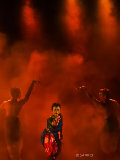 A striking image from 'Nagamandala' where the dancers appear as silhouettes in a red, smoky haze. This demonstrates how we use stagecraft to create powerful, almost cinematic visuals.