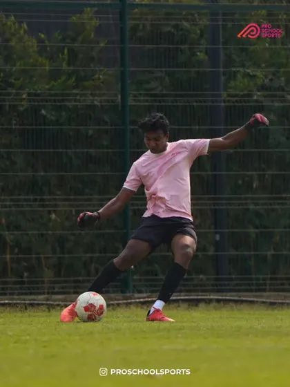 A coach demonstrates proper kicking technique during a practice session.