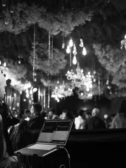 A black and white shot from behind the console, with beautiful chandeliers and decor in the background. The ambiance was incredible.