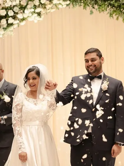 The recessional, with the couple walking down the aisle as husband and wife, showered with petals by their loved ones.