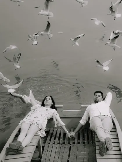 This is what it's all about for me. A quiet, shared moment on a boat, surrounded by the gentle flutter of birds. This black and white intimate portrait captures the pure, unspoken romance of a pre-wedding shoot.
